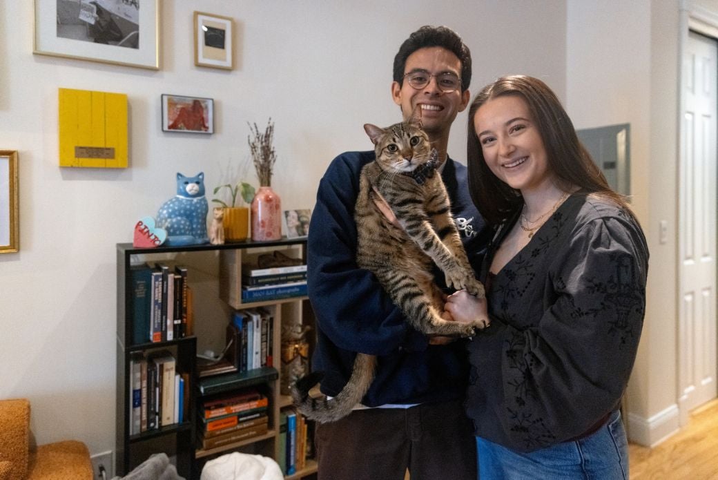 cat being held with adopters