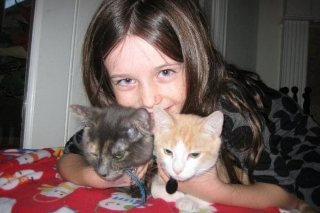 Child with 2 cats