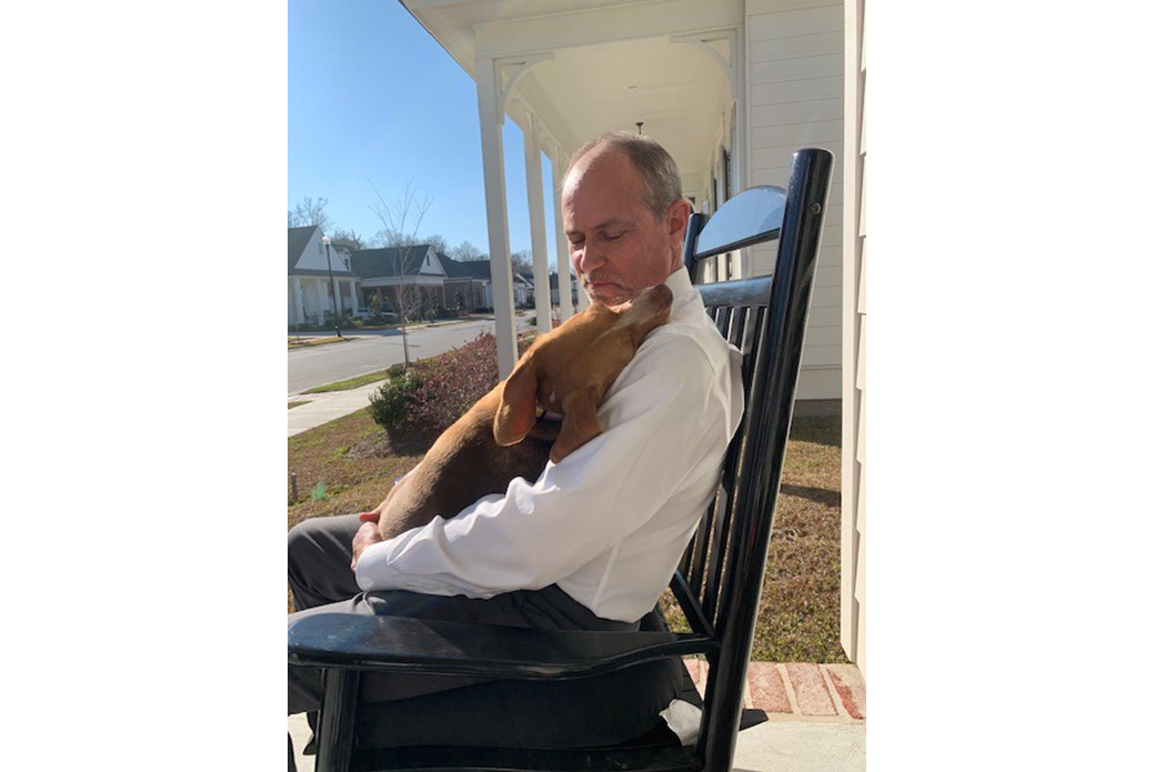 Daisy being held by outside on the front porch