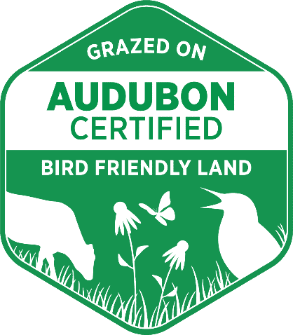 Audubon Certified Logo - Green badge with Grazed on Bird Friendly Land text on it and silhouette of cow and bird