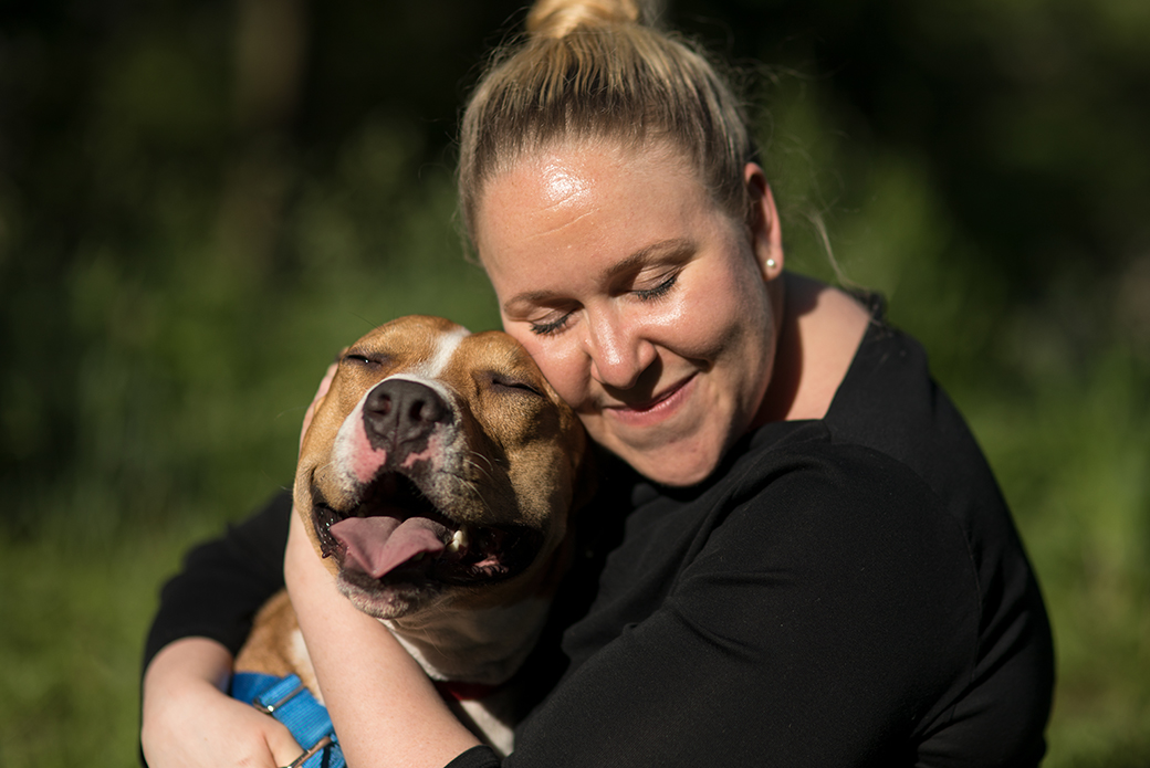 a woman hugging a dog