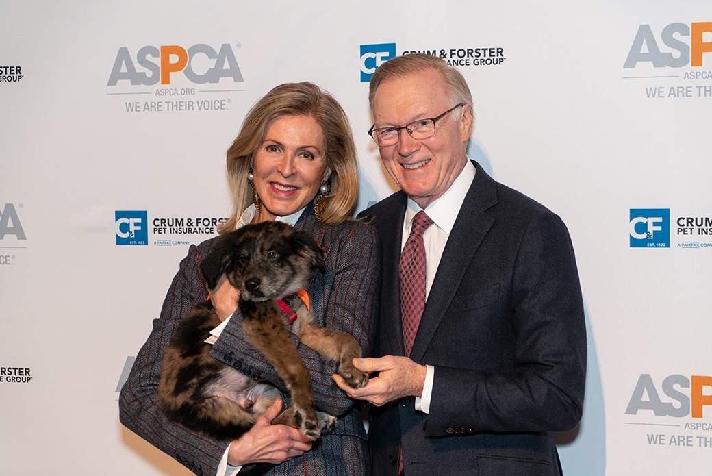 Chuck Scarborough with his wife, Ellen, holding a dog