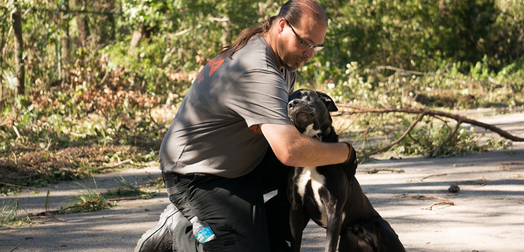 ASPCA volunteer holding a dog
