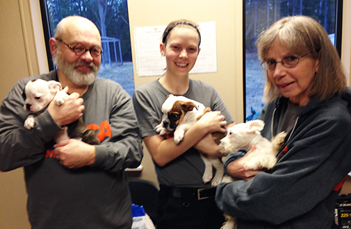 Molly and her parents holding pups 