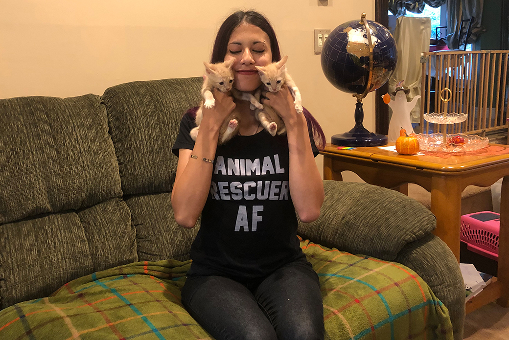 Emily holding her two foster kittens to her face