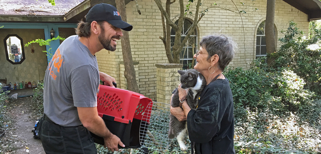 ASPCA responder E.G. Aguilar returning a cat to her pet parent