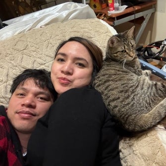 adopters laying with their new cat