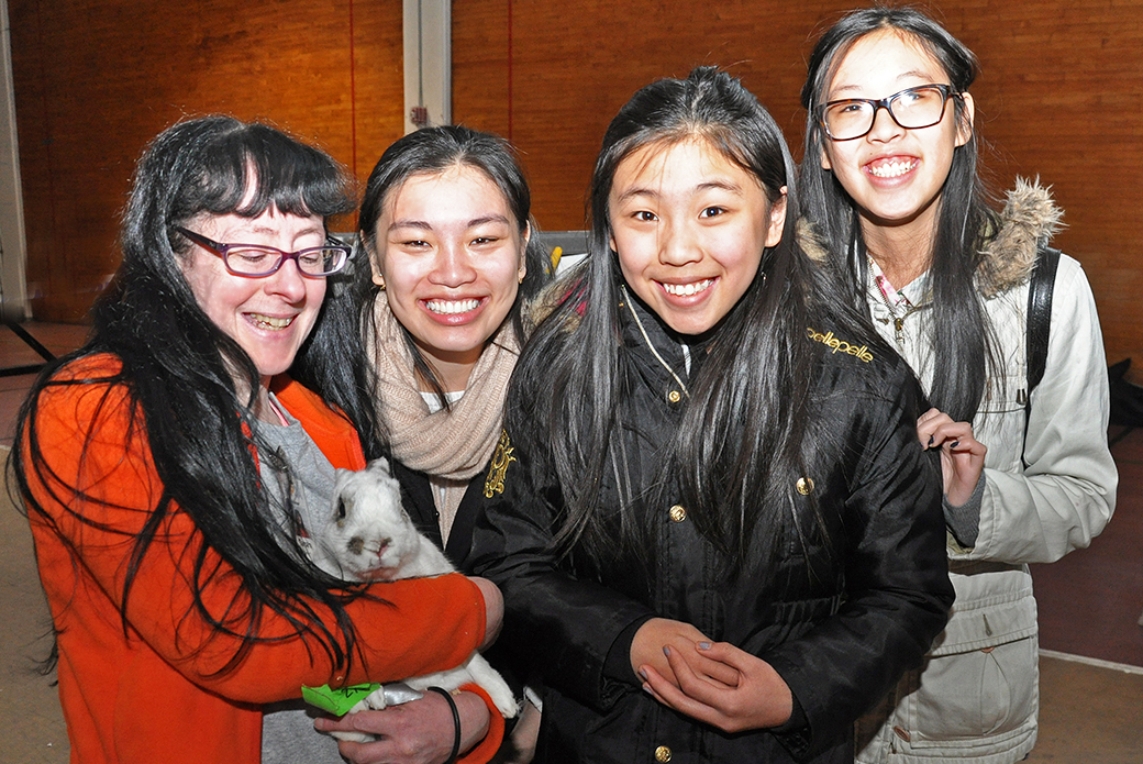 ASPCA Volunteer Tamara Bennett poses with Jericho and his new family.