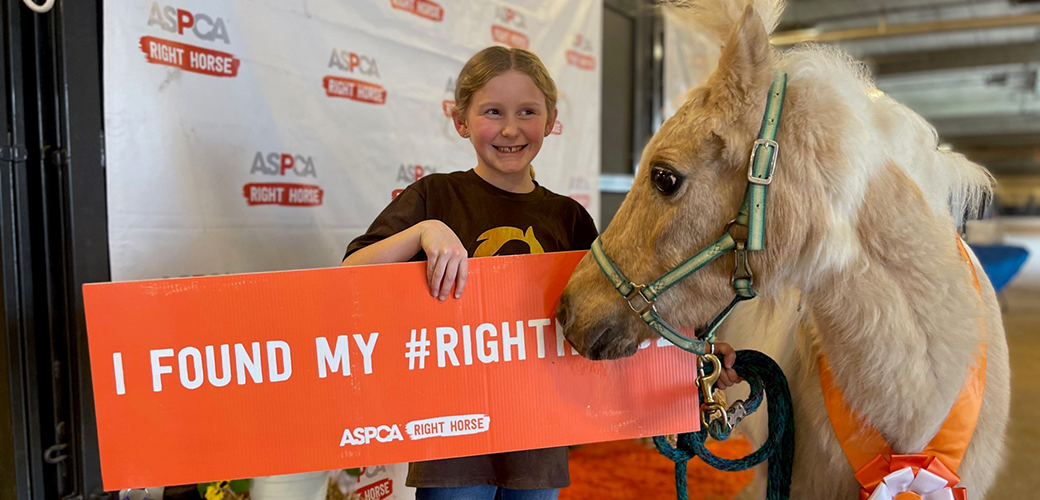 Fiona and Riley with Riley holding a I found my right horse sign
