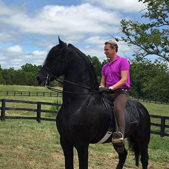 Carson Kressley riding a black horse
