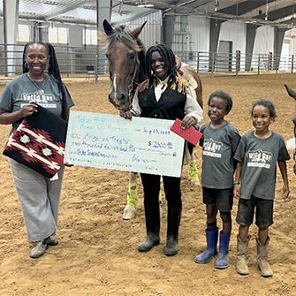 Angelica and Abigail posing with their family and horses